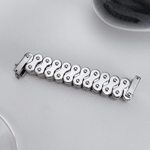 Detailed macro view of silver stainless steel motorcycle chain bracelet for men