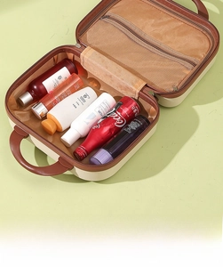Detail view of the macaron mini suitcase interior with mesh pocket and spacious compartment