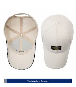 Detail view of beige cotton baseball cap showing internal branding and front embroidered tag