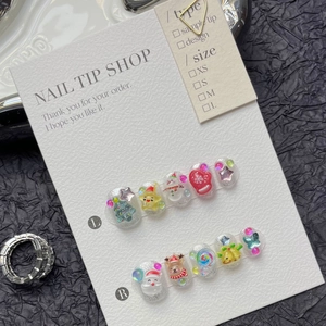 Detailed view of 3D Santa and reindeer handmade press-on nails on a display card