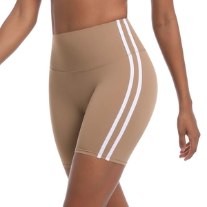 Close-up of camel yoga shorts featuring a high waistband and sporty white side stripes