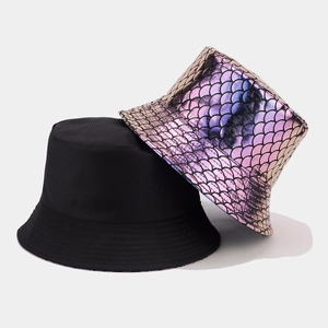 Detail of a reversible bucket hat showing matte black and shiny colorful fish scale textures