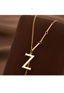 Macro shot of gold-plated titanium necklace with letter Z pendant on a luxury stand