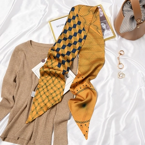 Retro mustard yellow geometric pattern silk scarf used as an elegant bag accessory