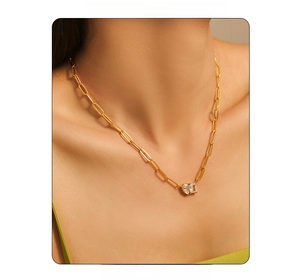Model wearing gold 18k plated paperclip chain necklace with zircon heart and square drops