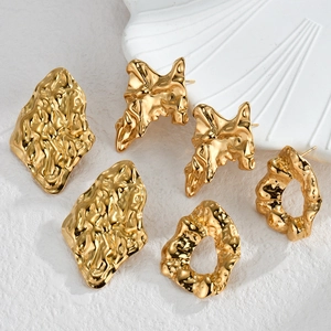 Three pairs of 18K gold irregular textured geometric earrings with lava finish on tray