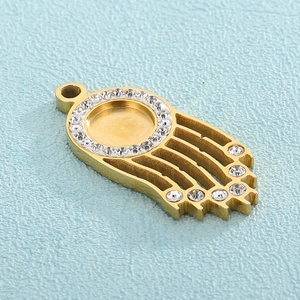 Gold Hamsa Hand pendant with a round rhinestone halo and clear zircon accents