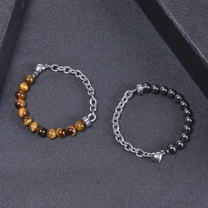Detail of heart magnet clasp on tiger eye and black stone beaded couple bracelet