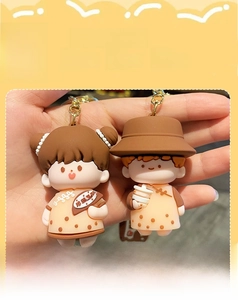 Close-up of cute cartoon couple keychains featuring bubble tea theme in soft PVC material