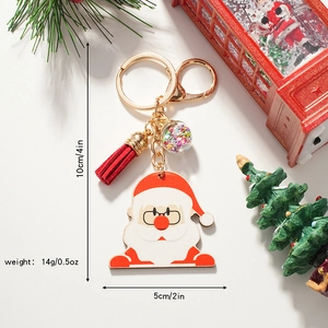 Detail view of Santa Claus keychain with red tassel and snow globe pendant size and weight