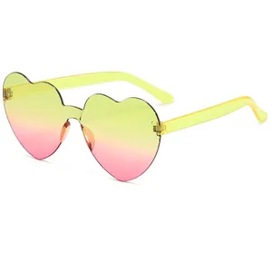 Frameless heart-shaped sunglasses with yellow and pink gradient lenses and yellow temples