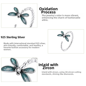 Macro detail of 925 sterling silver dragonfly ring with blue enamel wings and zircon stone