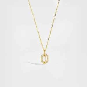 Macro detail of hexagonal pendant featuring emerald cut crystal and pavé zircon stones