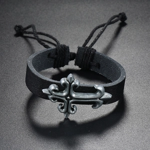 Vintage silver cross pendant on a black woven leather bracelet with adjustable cord
