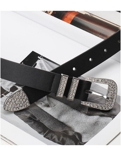 Close-up of black leather Y2K belt with sparkling rhinestone buckle and hardware