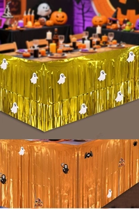 Detail of Halloween gold and orange fringe table skirts with ghost and bat paper cutouts