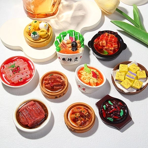 Collection of hyper-realistic Chinese food fridge magnets on a white display board