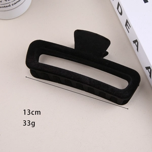Detail of 13cm black flocked hair claw clip showing 33g weight and internal teeth texture
