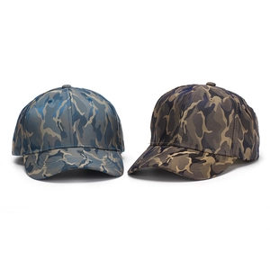 Detail shot of two camouflage baseball caps in blue-grey and tan patterns with curved brims
