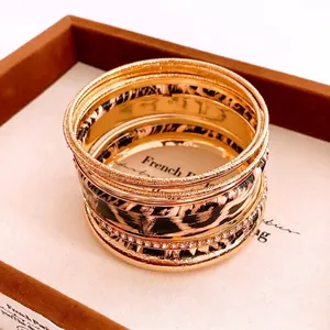 Retro gold and leopard print multi-layer bracelet set on elegant jewelry display tray