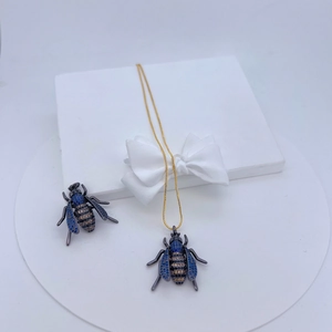 Exquisite gold-plated copper bee jewelry set with blue zircon inlay on white base