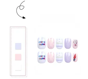 Detail of Easter press-on nails featuring cute cartoon rabbits, carrots and Happy Easter text