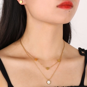 Double-layered gold shell pendant necklace and matching round stud earrings for women