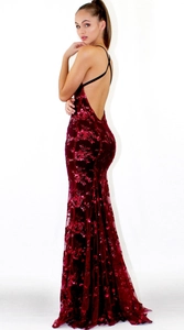 Detail of burgundy sequin evening dress showing backless design and crisscross straps