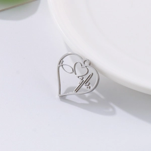Close-up of heart stethoscope pendant in polished silver stainless steel