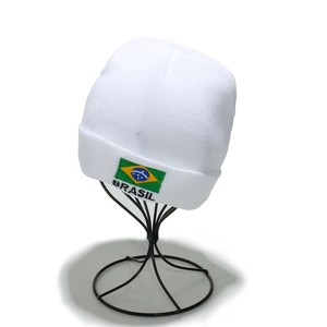 Close-up of Brazil flag embroidery and Brasil text on a white knitted beanie hat