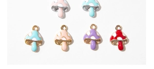 Macro shot of colorful enamel mushroom charms in red purple and blue alloy finish