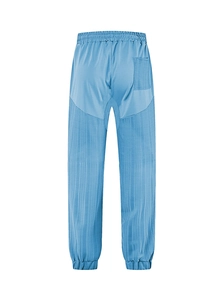 Detail of blue linen pants featuring elastic waistband and vertical texture stitching