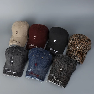 Flat lay of distressed baseball caps with Chicago embroidery in seven varied colors