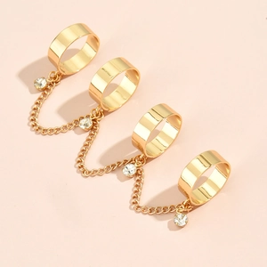 Detailed view of gold chain ring set with four adjustable bands and sparkling crystal accents