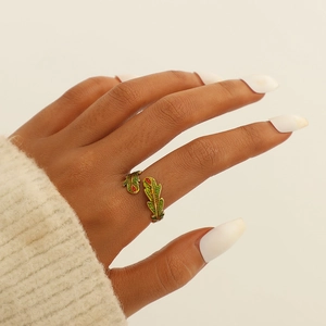 Detailed shot of peacock feather open ring with colorful enamel inlay on model hand