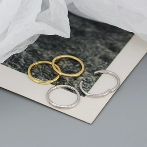 Close-up of S925 sterling silver minimalist hoop earrings in gold and silver finish