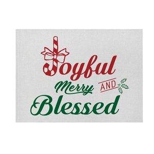 Detail of Christmas cotton linen placemat with festive text and candy cane prints