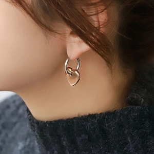Two-tone heart charm hoop earrings in polished silver and rose gold stainless steel