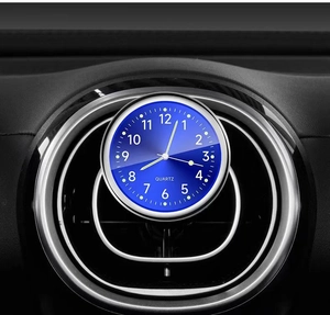 Luminous blue quartz car clock mounted on the dashboard vent for easy time reading