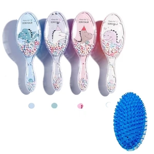 Detail view showing four colorful cartoon dinosaur air cushion hair brushes for kids