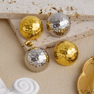 Detail of 304 stainless steel textured round stud earrings in gold and silver finish