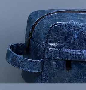 Detailed macro view of textured blue PU leather men's wash bag with sturdy metal zipper