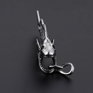 Detailed close-up of a silver shark bone pendant with clear fishbone texture