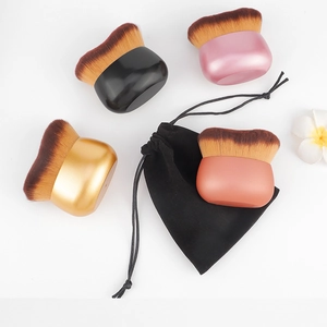 Detail view of multi-color flat foundation brushes with dense bristles and velvet pouch