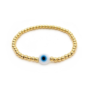 Minimalist gold plated beaded bracelet featuring a classic blue evil eye charm for women
