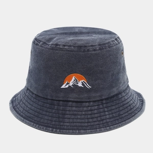 Detail of embroidered sun and snow mountain on grey washed denim bucket hat with eyelets