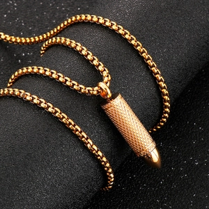 Titanium steel bullet pendant necklace with golden ball chain on black background