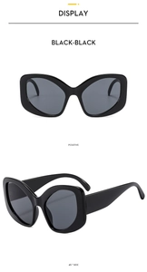Close-up of elegant black cat-eye sunglasses showing front and 45-degree side angles