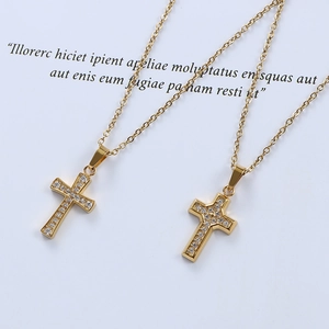 Close-up of gold cross pendant necklaces with micro-set zircons on a white background