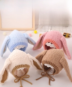 Detailed close-up showing plush bunny ear hats in blue, pink, beige, and brown colors